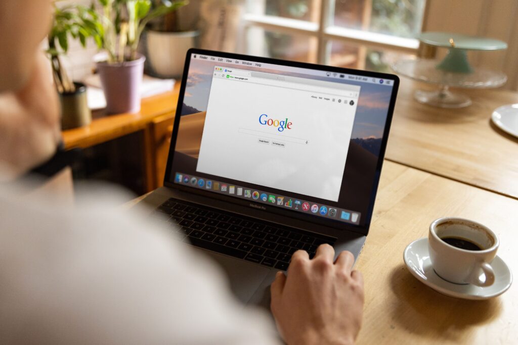 Person browsing Google Search on a laptop for online research and SEO insights.